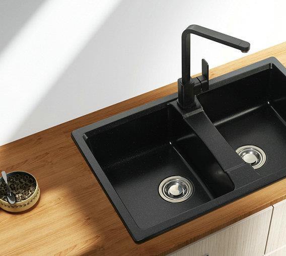 Black quartz double bowl kitchen sink set into a timber worktop