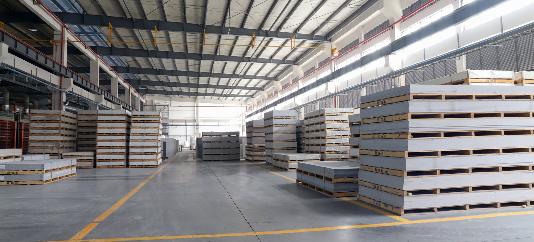 Finished quartz slabs stacked on pallets in the warehouse at the OPALY plant